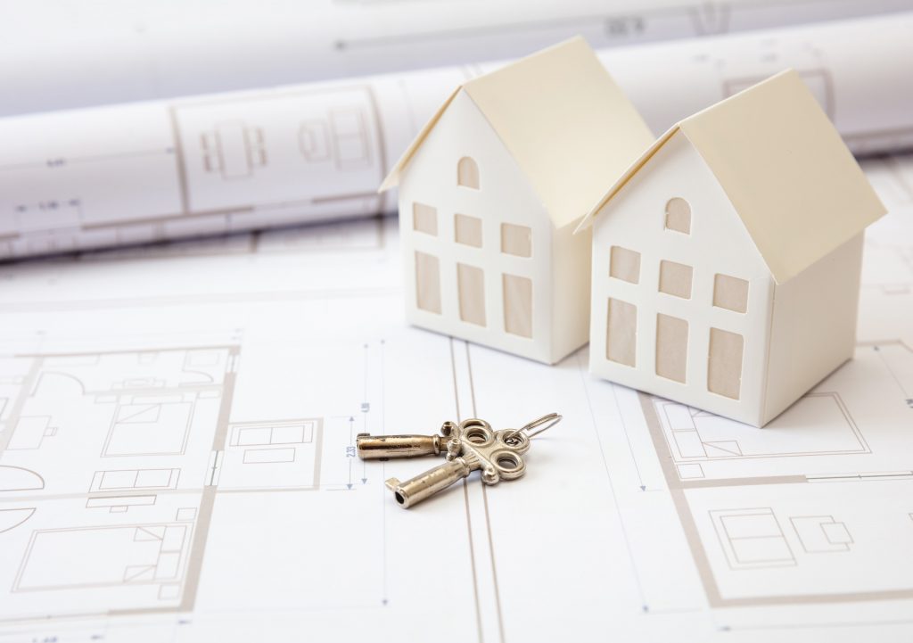 Construction design blueprints. Keys on housing plans, Real estete development project. Contractor, realtor work space